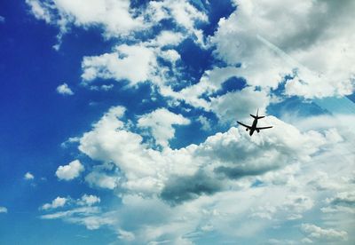 Low angle view of airplane flying in sky