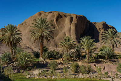 Rock formations on mountain against clear blue sky