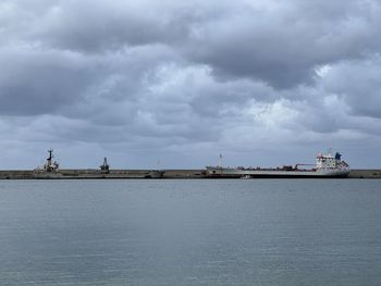 Shipyard and pier with big ships docked. cloudy sky in sicily.