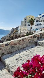 Scenic view of sea by buildings against sky