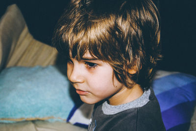 Close-up of boy looking away at home