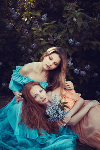 High angle view of young women sitting on grass