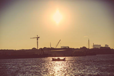 Boats in harbor at sunset