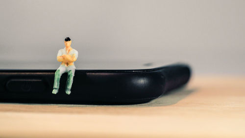 Close-up of toy on table against white background