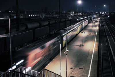 High angle view of train at railroad station at night