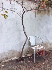 Empty chair against wall