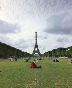 People in front of tower against sky