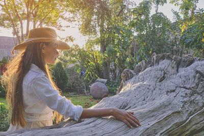 Young woman sitting on rock