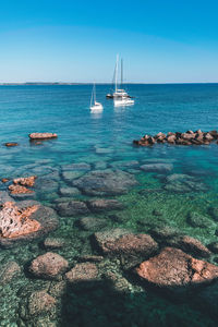 Sailboats on sea against sky