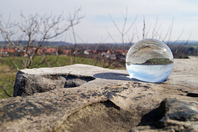 Close-up of crystal ball on rock