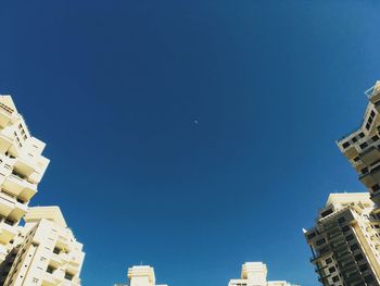 Low angle view of buildings against blue sky