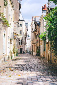 Footpath amidst buildings in town