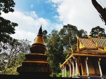 Low angle view of pagoda against cloudy sky