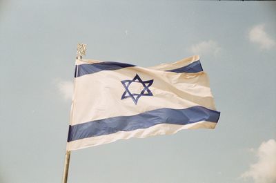 Low angle view of israeli flag against sky
