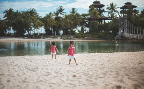 Rear view of women walking on beach