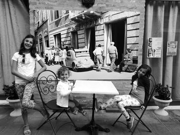 Rear view of people sitting on table