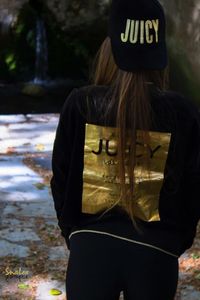 Rear view of woman standing against tree