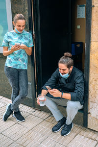 Waitress and chef making a break at the back door of the restaurant