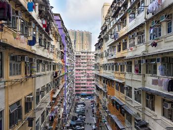 Residential buildings in city against sky