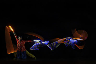 Man with light painting performing on stage