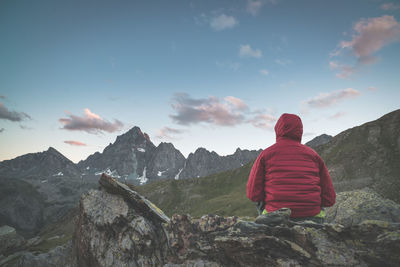 Rear view of person against mountain range