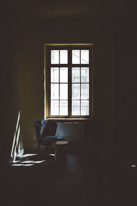 Chair by window in empty room