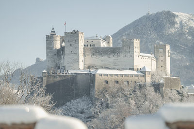 Snow covered fortress hohensalzburg above salzburg, austria