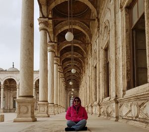 Portrait of woman against historic building