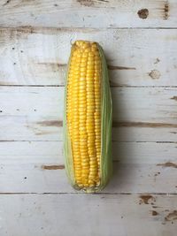 Directly above shot of corn on wooden table