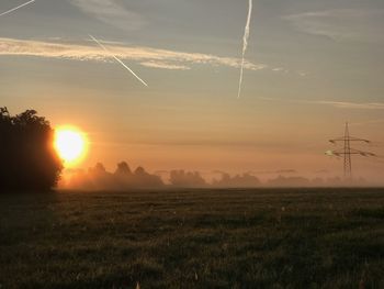 Scenic view of field against sky during sunset