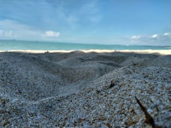 Surface level of beach against sky