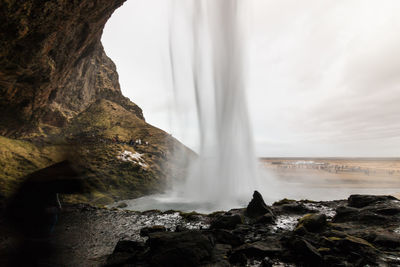 Scenic view of waterfall falling from mountain