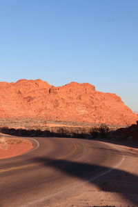 Low angle view of rock formations against clear blue sky