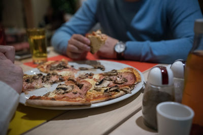 Midsection of man preparing food in restaurant
