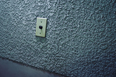 Close-up of electric light on wall