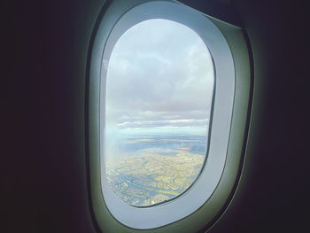 Cloudy sky seen through airplane window