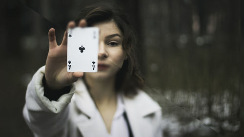 Portrait of young woman holding camera