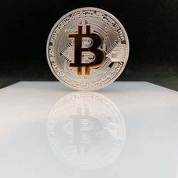 Close-up of clock on table against black background