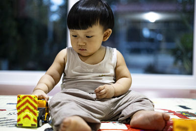 Portrait of cute boy eating food at home