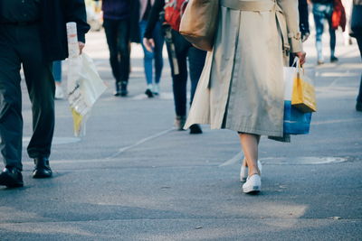 Low section of people walking on road