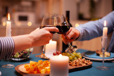 Cropped hand of person preparing food on table