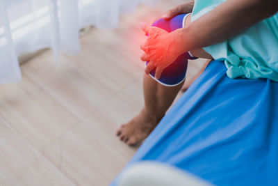 Low section of woman sitting on floor