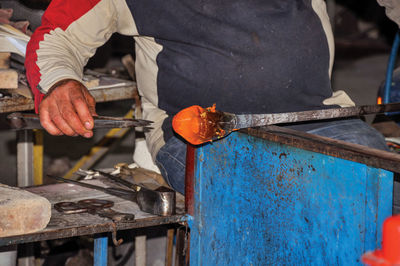 Man working on barbecue grill