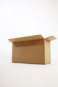 Close-up of cardboard box over white background