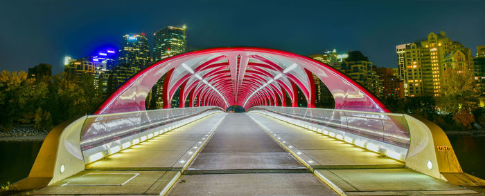 View of illuminated bridge and buildings at night