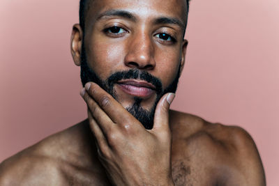 Portrait of young man against white background