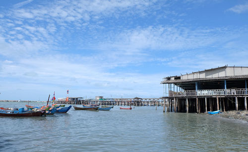 Boats moored in sea against sky
