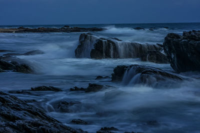 Scenic view of waterfall against sky