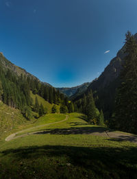 Scenic view of mountains against clear blue sky