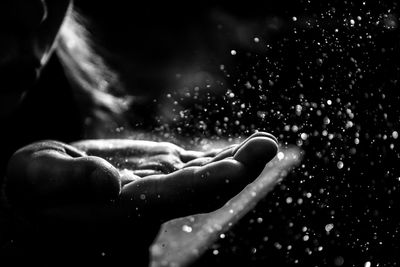 Close-up of woman hand with water drops